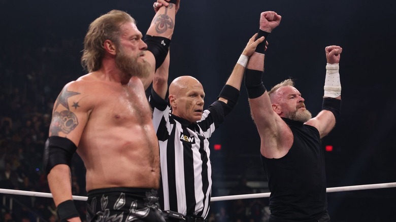 Adam Copeland and Christian Cage raising their hands