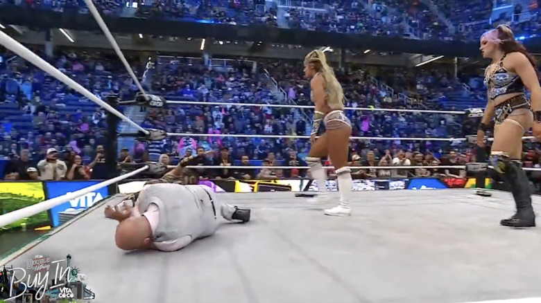 Bayne and Kross standing over Daniels and Van in the ring post-match