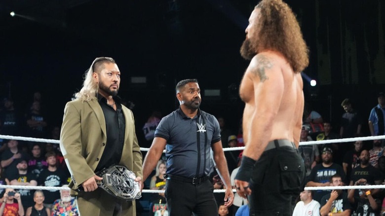 Naraku, holding the NXT title, stares down NXT Champion Tony D'Angelo from across the ring as a referee loos on during an episode of "WWE NXT."