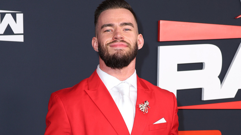 Austin Theory wearing a red blazer