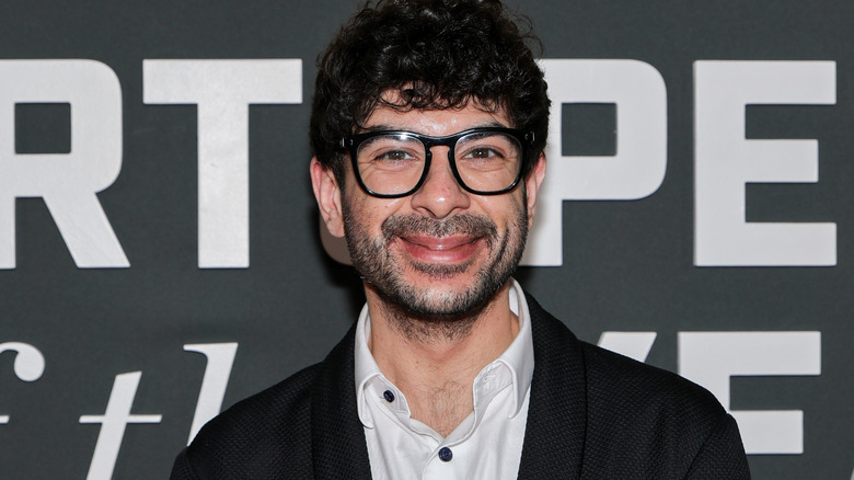 Tony Khan wearing glasses