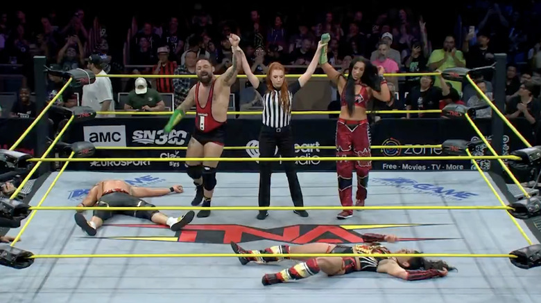 The referee raising Marella and Hartwell's hands