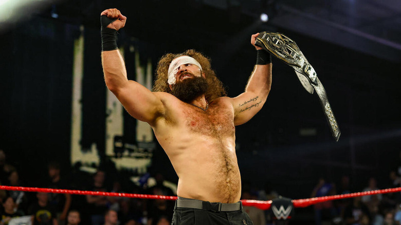 Tony D'Angelo holds the NXT Title high