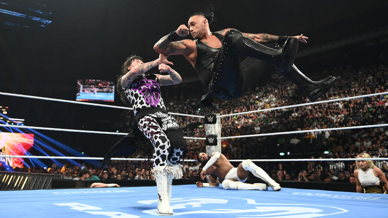 Damian Priest hits a back elbow on Dominik Mysterio as Trick Williams and Liv Morgan look on on "WWE SmackDown"