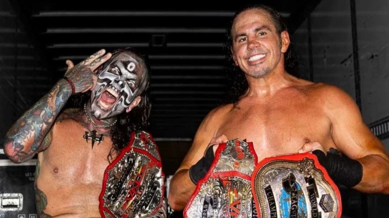 Jeff and Matt Hardy pose with the TNA World Tag Team Championships backstage after a victory on TNA programming.