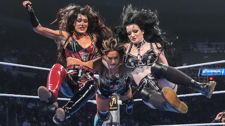 Brie Bella and Paige hit a double team move on Fallon Henley on "WWE SmackDown"