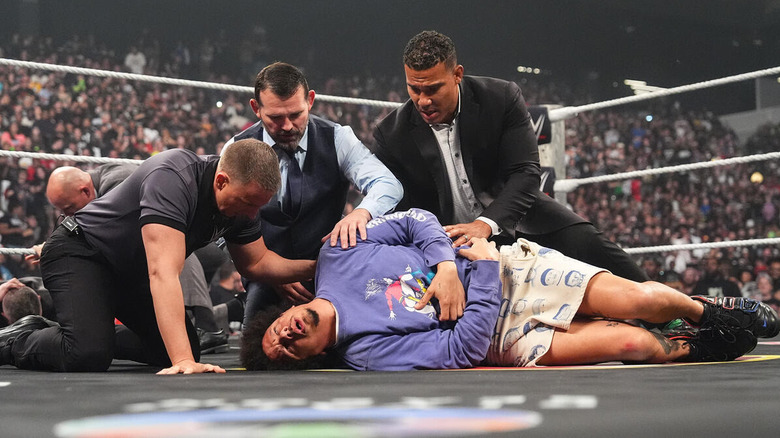 WWE producers check on a fallen Eric Andre on "WWE Raw"