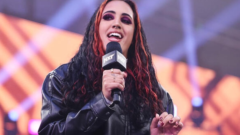 Ava speaks into a microphone on 