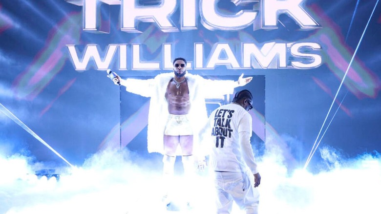 Trick Williams poses on his turn table on the stage, with rapper Lil Yachty by his side, during an episode of "WWE SmackDown."