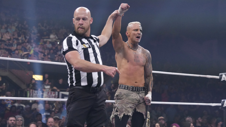 A referee raising Allin's hand