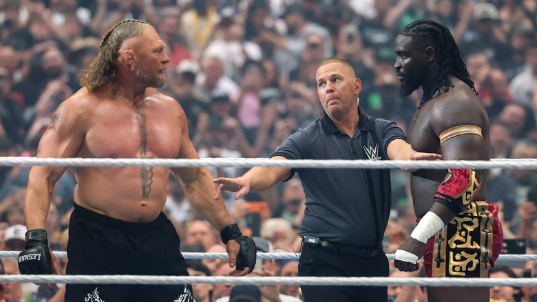 Brock Lesnar and Oba Femi being separated by the referee