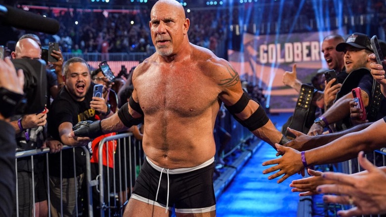 Goldberg gives high fives to fans as he walks down the ramp to the ring to face GUNTHER at Saturday Night's Main Event.