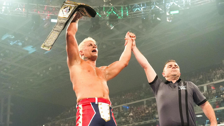 Cody Rhodes raises the WWE Undisputed Champion over his head