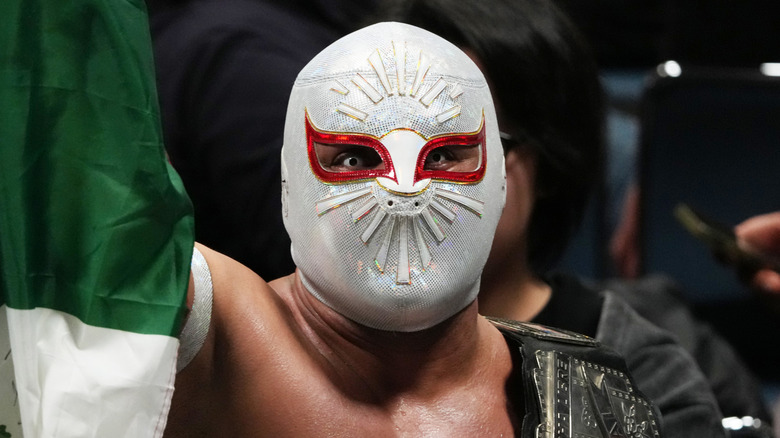 Mistico holding up the Mexican flag