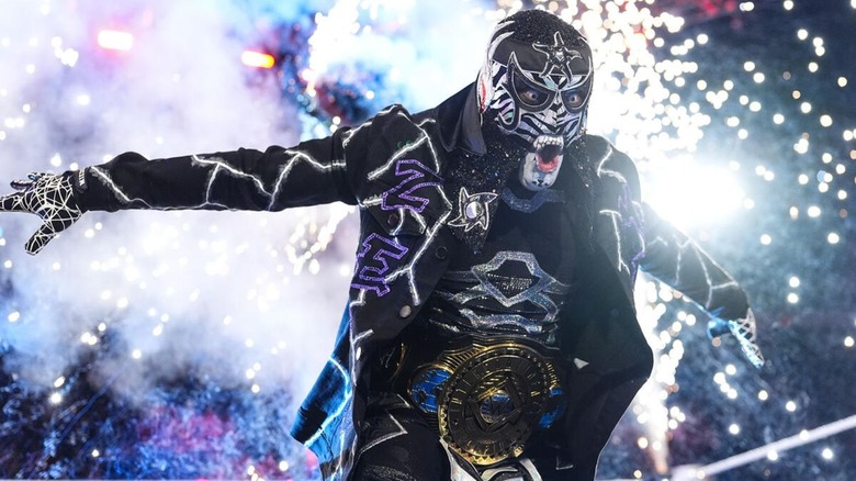 Intercontinental Champion Penta poses in the ring, his pyro going off behind him, before a match on "WWE Raw."