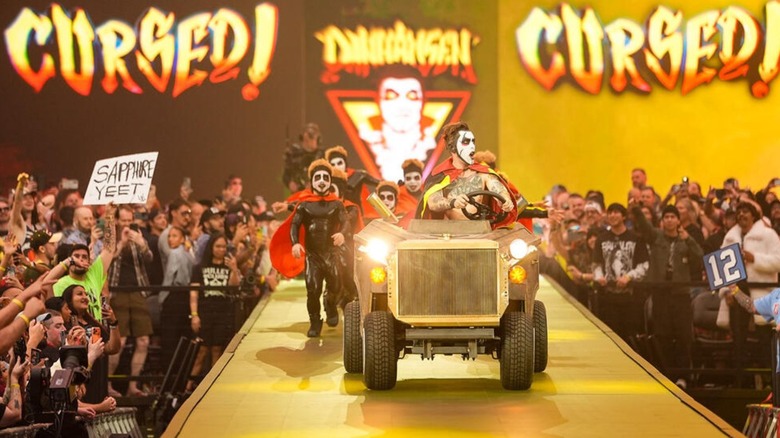 Danhausen, driving the Danhausen-mobile, heads down the ramp to the ring, flanked by the Minihausens, at WWE WrestleMania 42.