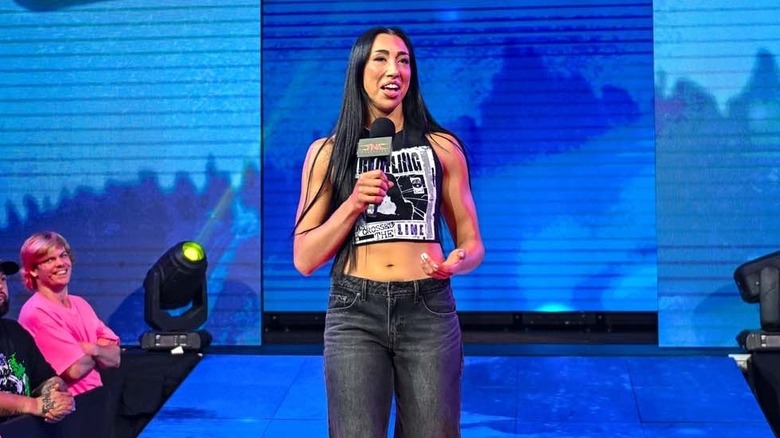 Indi Hartwell talking into a TNA mic