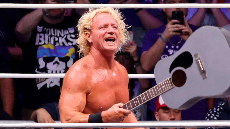 Jeff Jarrett holds a guitar