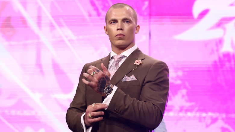Kyle Fletcher stands on the stage, looking to the ring at rival Konosuke Takeshita, during an episode of "AEW Dynamite."