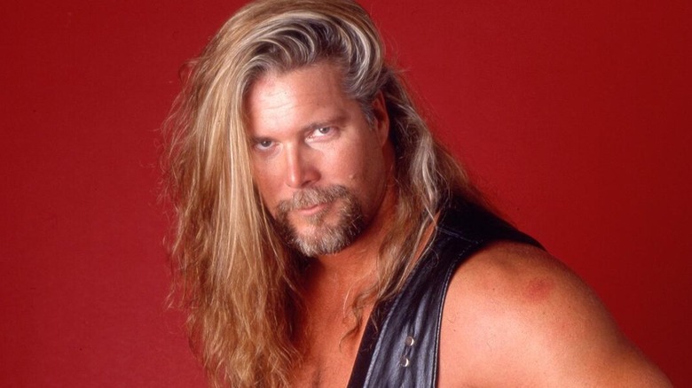 Kevin Nash poses for a photoshoot backstage in WWE