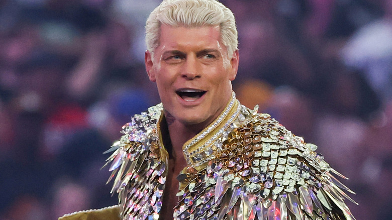 Cody Rhodes wearing a gold ring jacket
