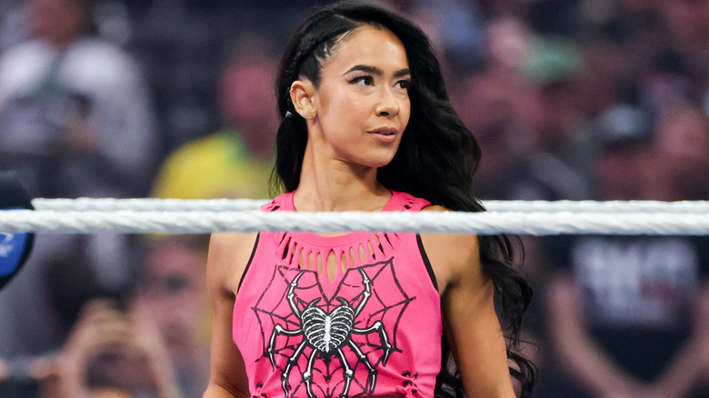 AJ Lee wearing a pink shirt