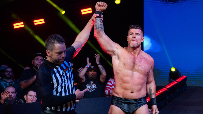 Steve Maclin with his arm raised in victory