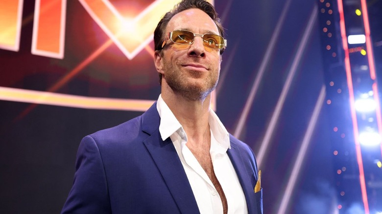 LA Knight, as his previous Max Dupri character, poses on the stage before a segment on "WWE SmackDown."