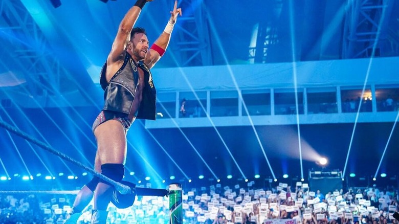 LA Knight looks out into the crowd who are holding up "YEAH" signs at Crown Jewel