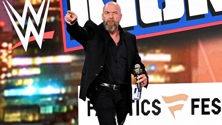Paul Levesque with a microphone