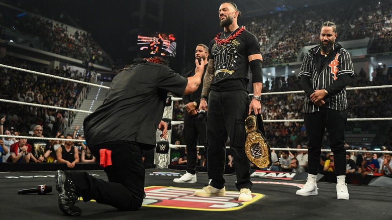 Jacob Fatu kneels before World Heavyweight Champion Roman Reigns, with the Usos flanking Reigns, during the acknowledge ceremony to open the June 1, 2026 edition of "WWE Raw."