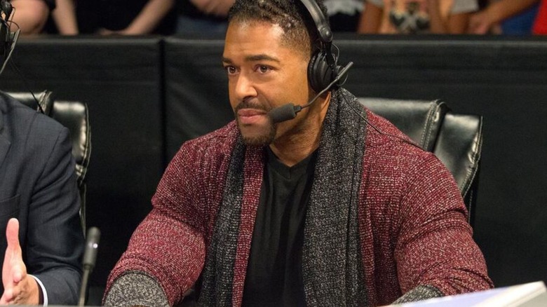 David Otunga sits on commentary during a match on an episode of WWE programming.