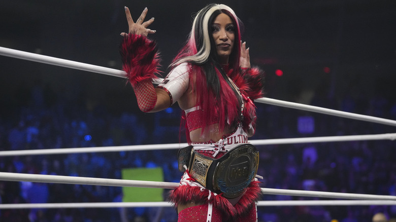 Then-TBS Champion Mercedes Mone poses on the ring apron, the belt around her waist, before a match on the December 31, 2025 edition of "AEW Dynamite."