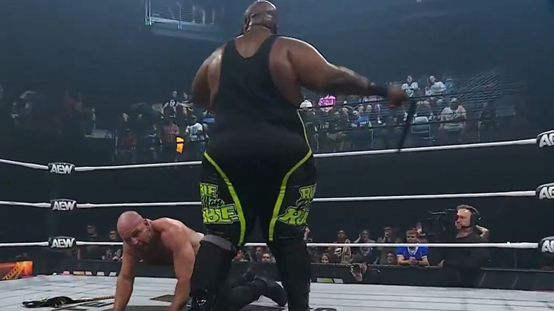Shane Taylor goes to hit Jon Moxley with a belt