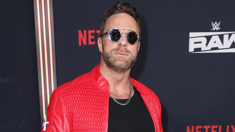 LA Knight in sunglasses and a red jacket