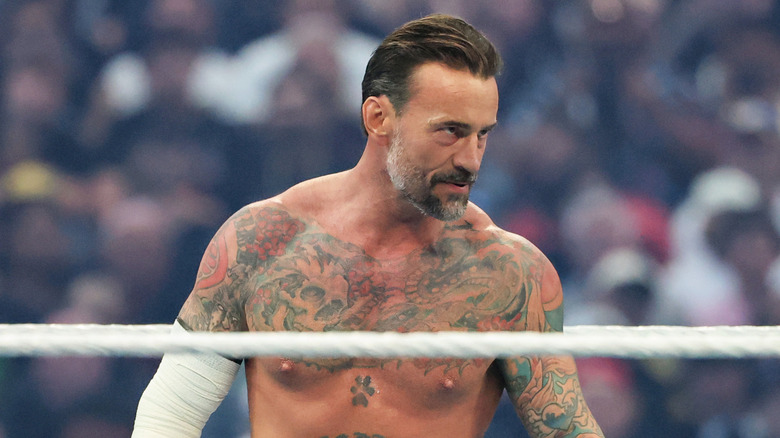 CM Punk waits in the ring for the start of his match against Roman Reigns for the World Heavyweight Championship