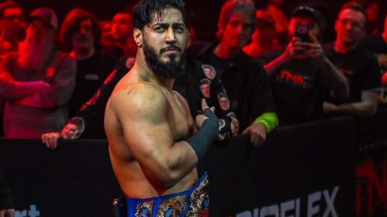 Mustafa Ali prepares to head into the ring with his TNA International Championship
