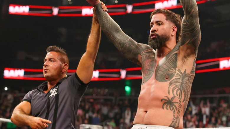 A referee holds up the arm of Jey Uso after a victory on an episode of "WWE Raw."