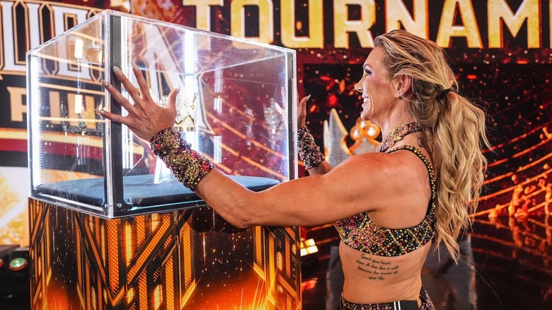 Charlotte Flair stares at the Queen of the Ring crown on 
