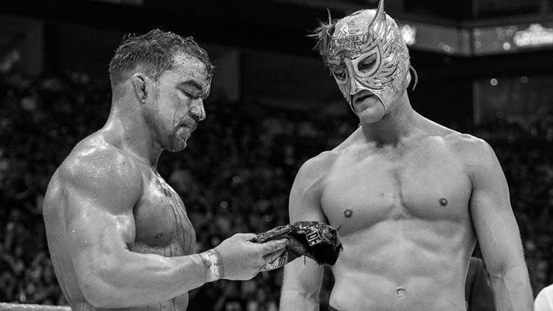 "The Original" El Grande Americano (Chad Gable) hands his mask over to El Grande Americano after their emotionally charged match