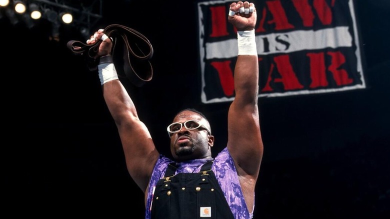D-Von Dudley proudly holds a belt in his hand after defeating an opponent with it on "WWE Raw" during the Attitude Era