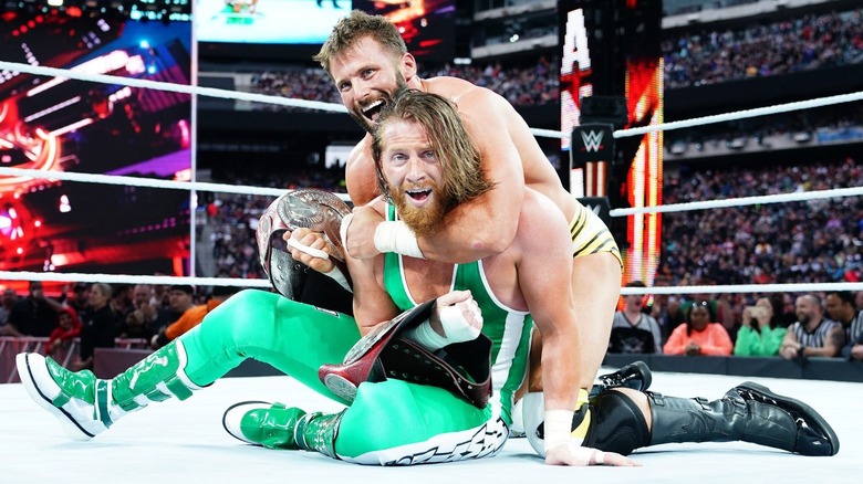 Zack Ryder (Matt Cardona) hugs Curt Hawkins (Brian Myers) after winning the former WWE Raw Tag Team Championships