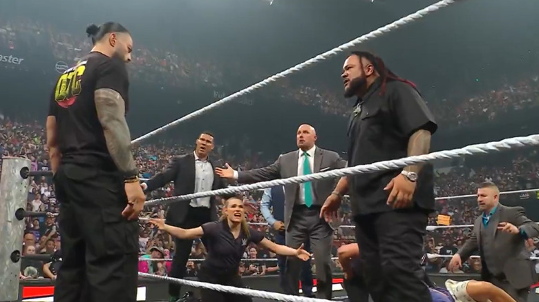 Roman Reigns and Jacob Fatu survey the latter's attack on Eric Andre