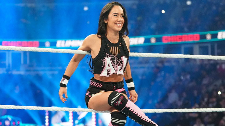 AJ Lee hanging onto ring ropes