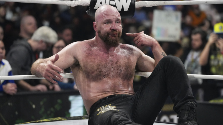 AEW Continental Champion Jon Moxley points to himself, while making a face, sat in the corner following a match against Will Ospreay at AEW Dynasty 2026.