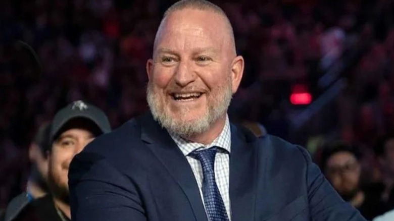 Former WWE producer Road Dogg sits on a broadcast panel for a WWE event.