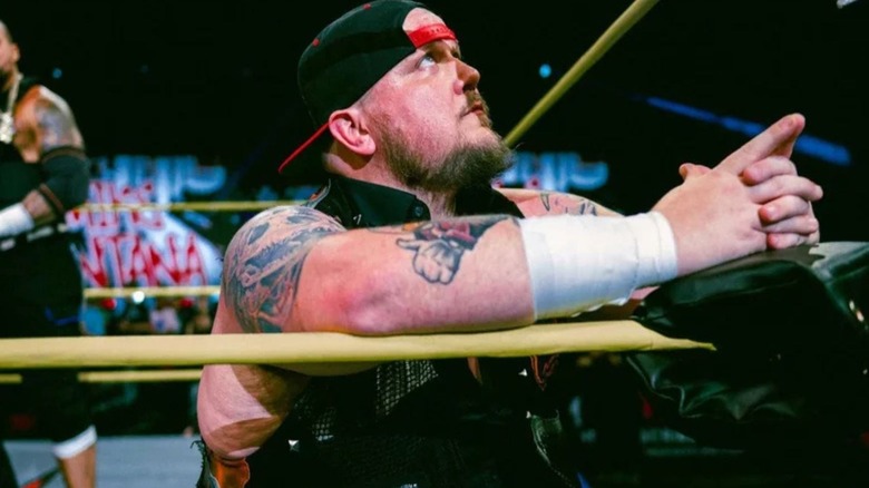 Sami Callihan kneels in the corner of the ring ahead of a match in TNA.