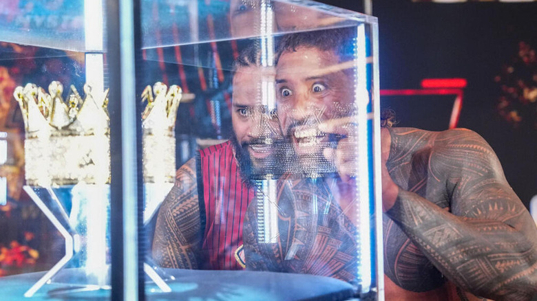 Jey and Jimmy Uso entranced by the King of the Ring crown