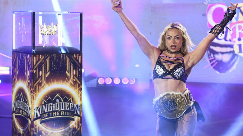 Liv Morgan next to the case with the Queen of the Ring crown