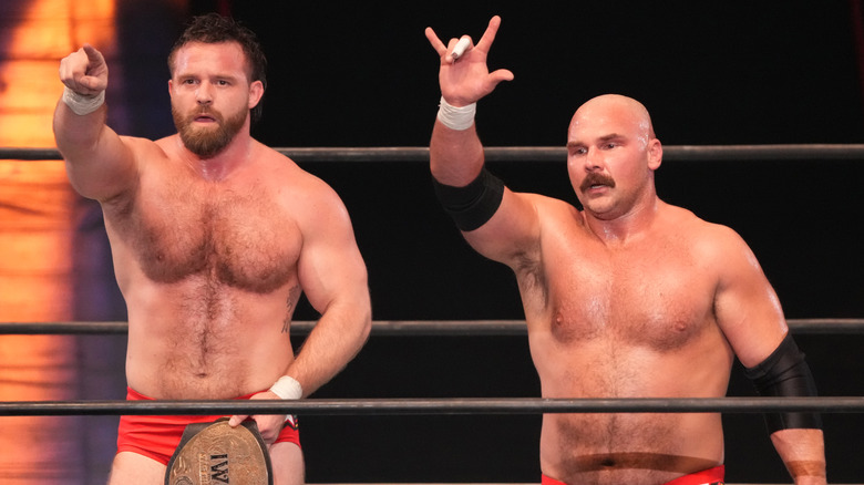 Cash Wheeler and Dax Harwood standing in a wrestling ring